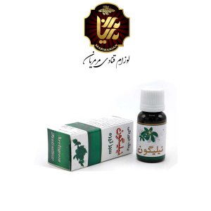 یک قوطی رنگ مایع سبز تیره نیلیگون در کنار بسته بندی آن