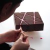 یک فرد در حال ریختن ماده خوراکی بر روی قالب سیلیکون هندسی طرح مثلث